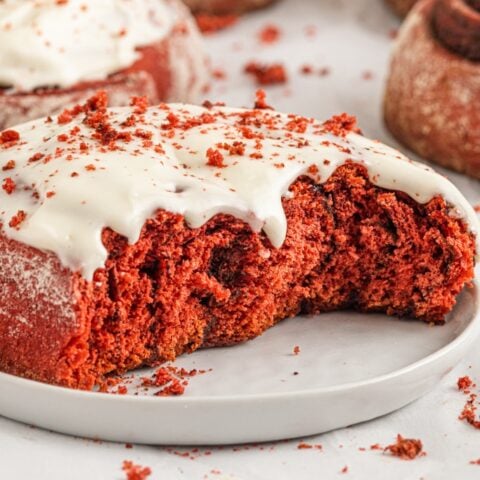 Red Velvet cinnamon roll with a bite out of it