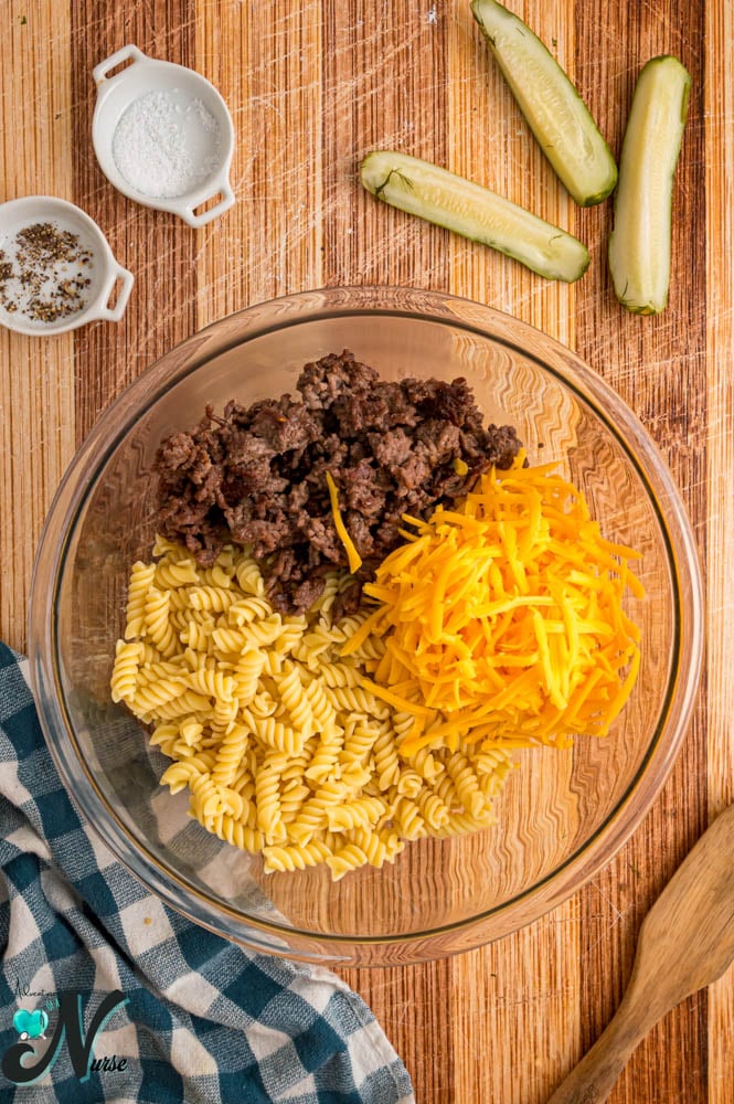 add-pasta-ground-beef-and-meat-to-a-bowl.