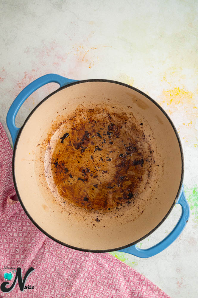 rowned bits and cooking juices in a Dutch oven after removing the lamb.