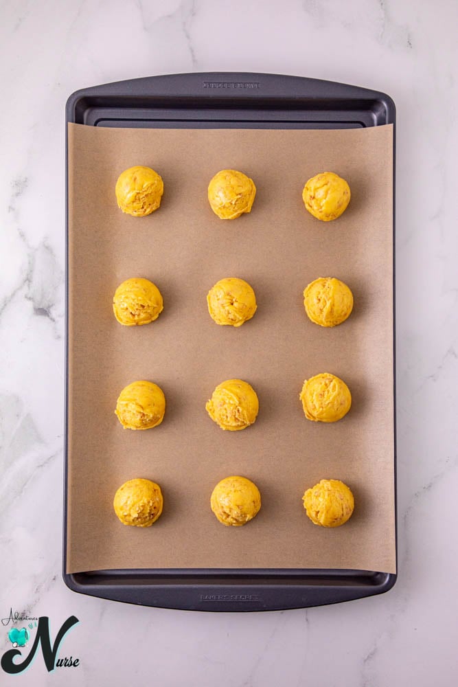 cookie balls on baking sheet
