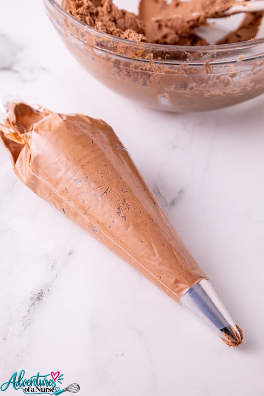 use a piping bag to frost the cupcakes